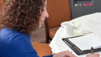 woman writing on paper